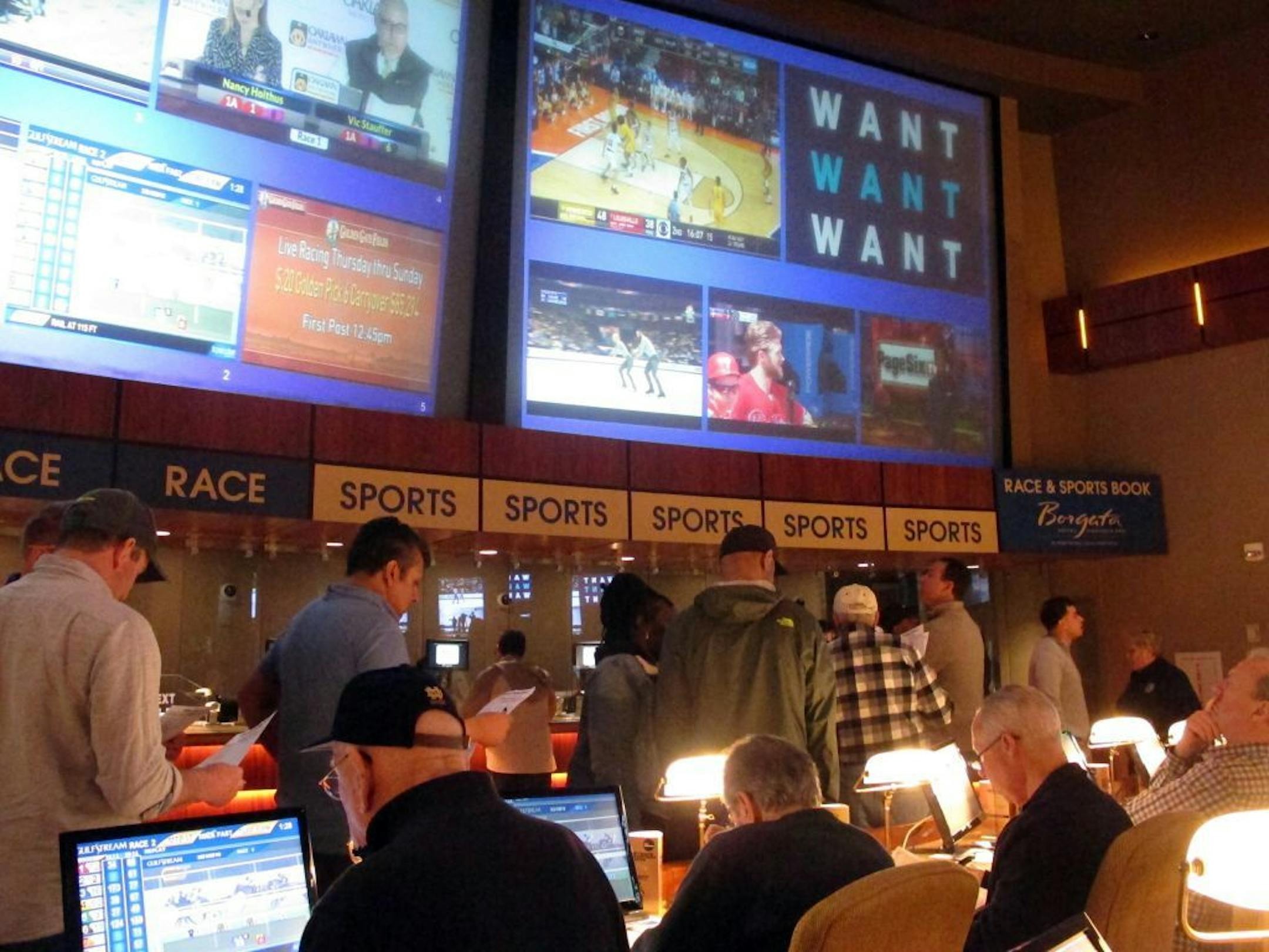 Gamblers line up to place bets on the NCAA men's college basketball tournament at the Borgata casino in Atlantic City N.J., Thursday, March 21, 2019. This is the first March Madness tournament since legal gambling expanded last year in the U.S.