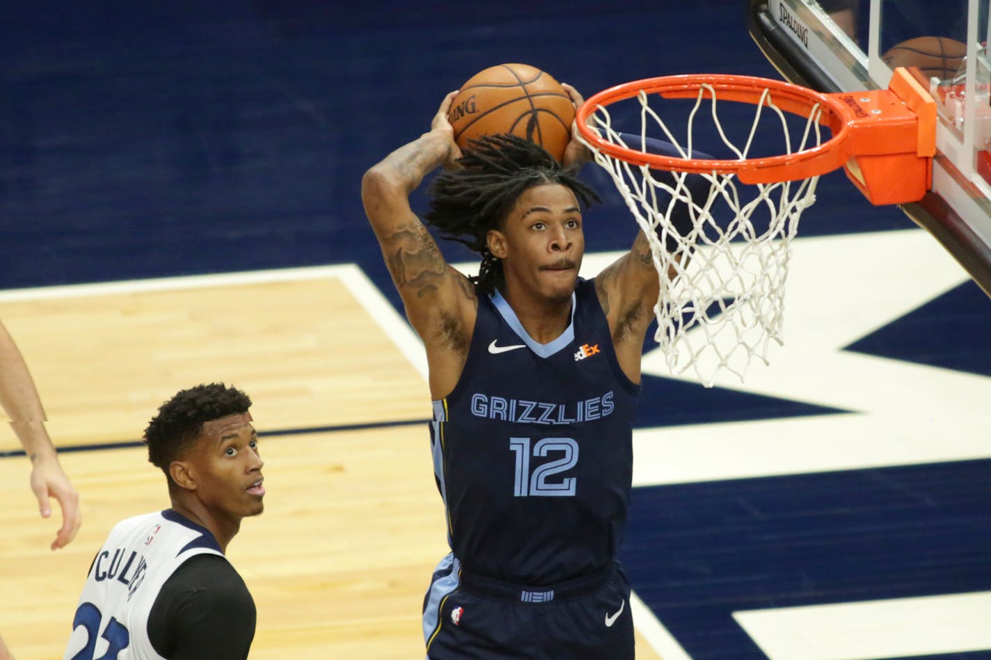 Memphis Grizzlies guard Ja Morant (12) dunks in front of Minnesota Timberwolves Jarrett Culver (23) in the third quarter during an NBA preseason basketball game, Saturday, Dec. 12, 2020, in Minneapolis. (AP Photo/Andy Clayton- King)