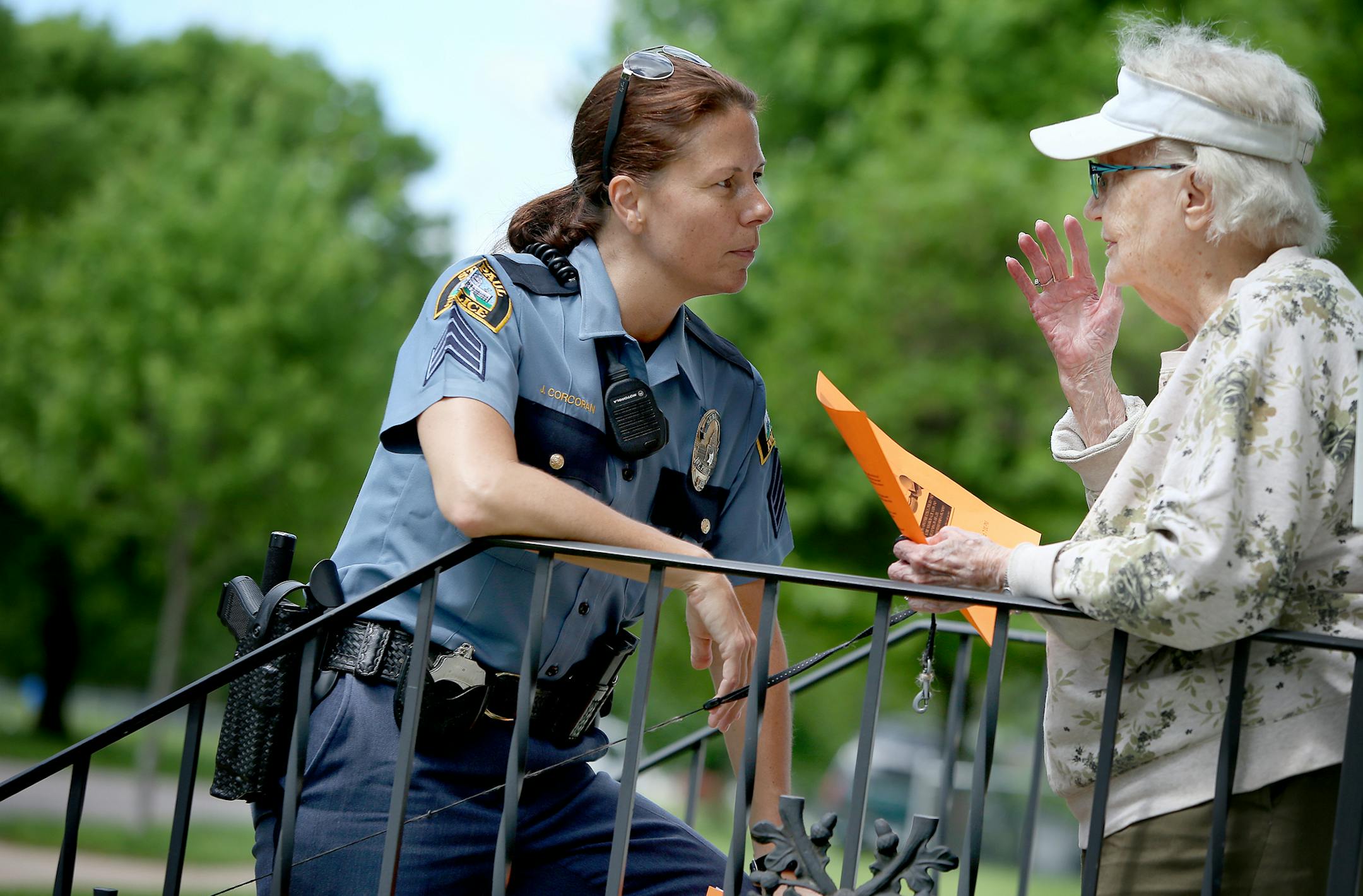 Police Sgt. Jennifer Corcoran listened to 90-year-old Marge Faini as officers went from house to house handing out flyers recently on St. Paul’s East Side.