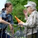Police Sgt. Jennifer Corcoran listened to 90-year-old Marge Faini as officers went from house to house handing out flyers recently on St. Paul&#x2019;