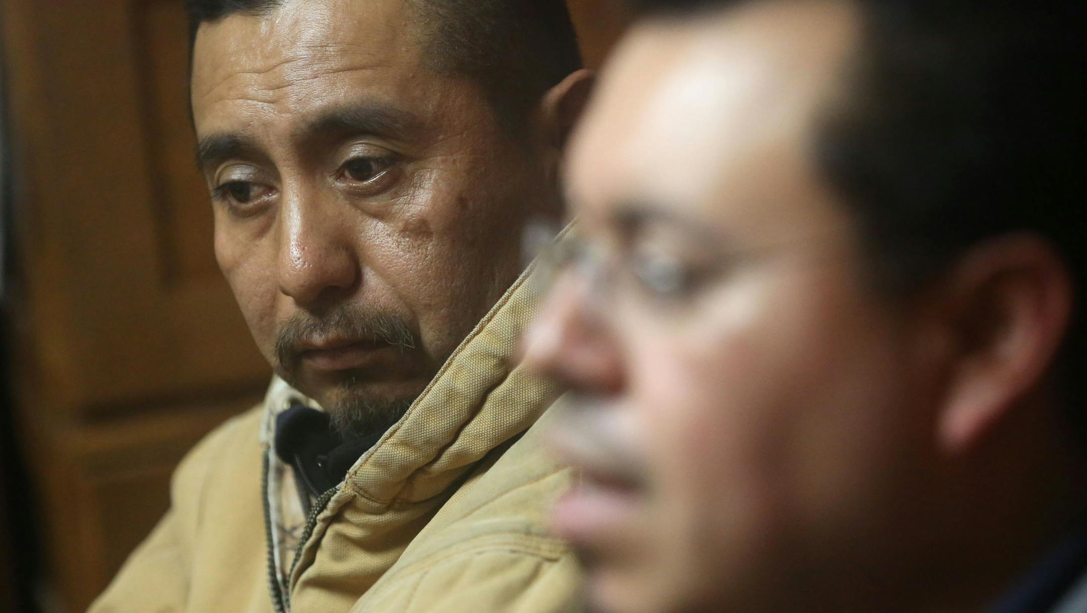 Benito Tapia Morales listened as Mayolo Garcia talked about how he and others felt discriminated against during their hunting trip when they were stopped DNR officers and some of their group detained at the office of Attorney Bruce Nestor in Minneapolis, Wednesday, December 3, 2013. ] (KYNDELL HARKNESS/STAR TRIBUNE) kyndell.harkness@startribune.com