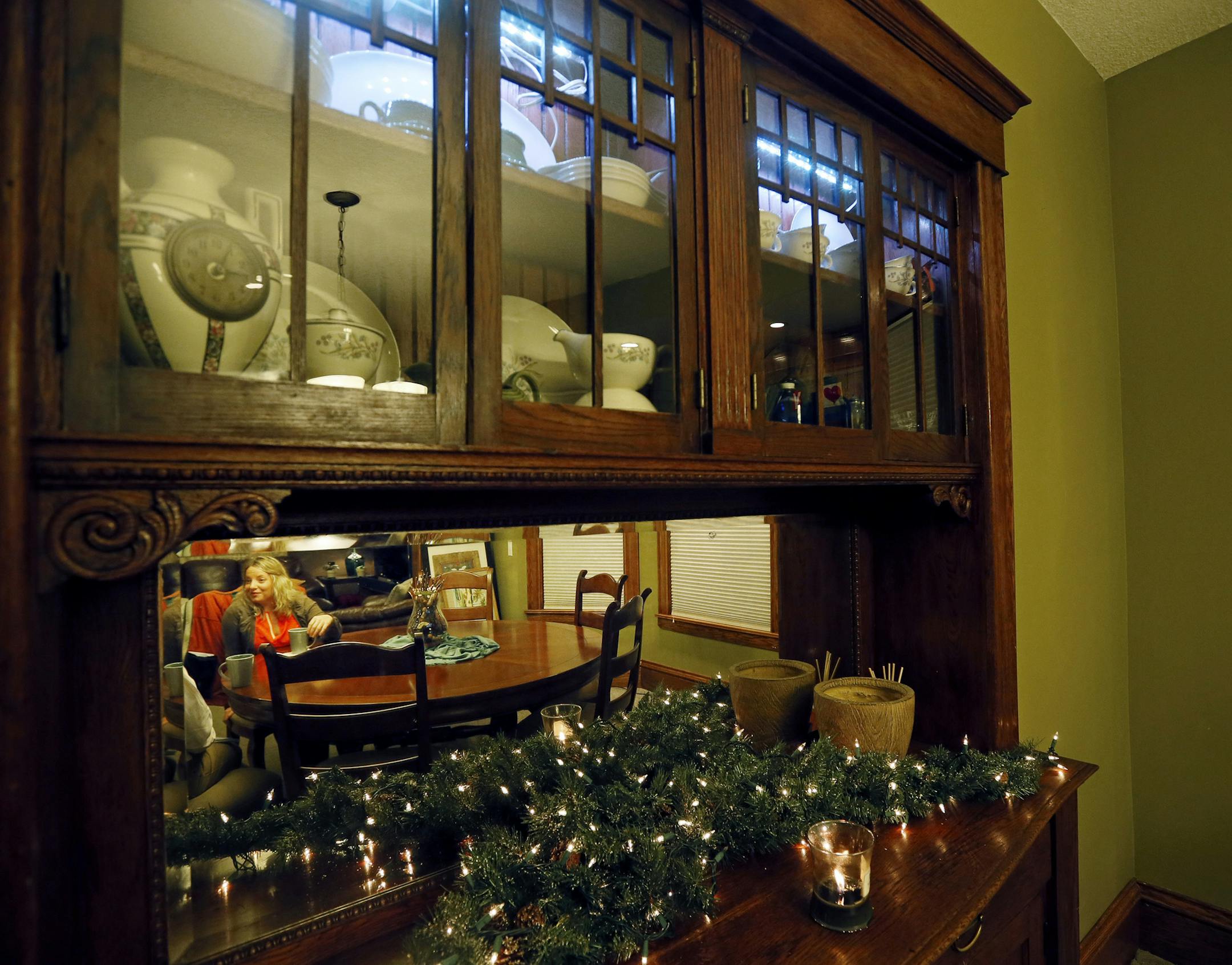 Jill Asfoor was reflected in the glass of a built in buffet, in the Highland area on the north side January 14, 2015 Minneapolis, MN.] Jerry Holt/ Jerry.Holt@Startribune.com