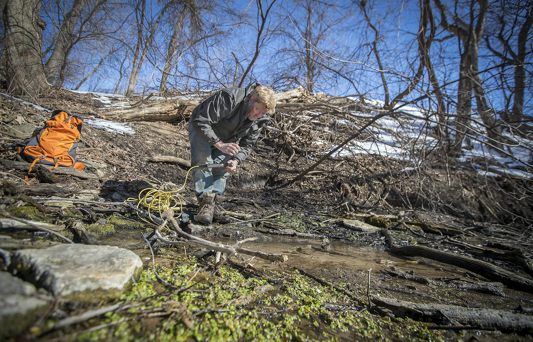 DNR spring hunter Greg Brick checked the water temperature in a spring hidden near the Mall of America, Thursday, March 1, 2018 in Bloomington, MN. ] ELIZABETH FLORES &#xef; liz.flores@startribune.com