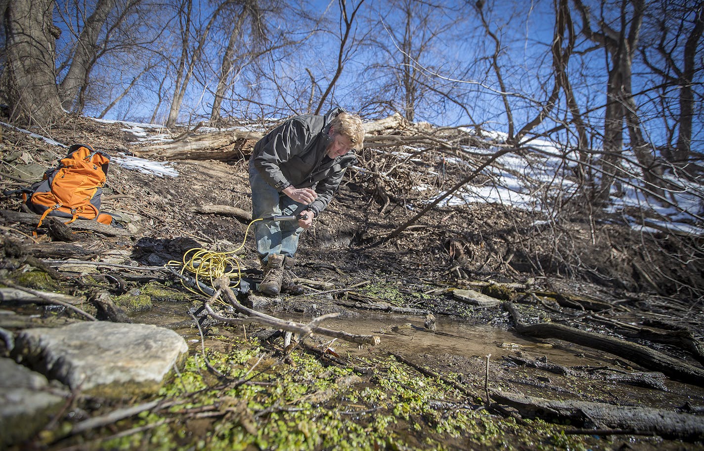 DNR spring hunter Greg Brick checked the water temperature in a spring hidden near the Mall of America, Thursday, March 1, 2018 in Bloomington, MN. ] ELIZABETH FLORES &#xef; liz.flores@startribune.com