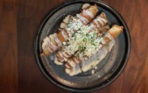 The flautas on the appetizer menu are tortillas wrapped around potato before being fried crispy and served under sauce.