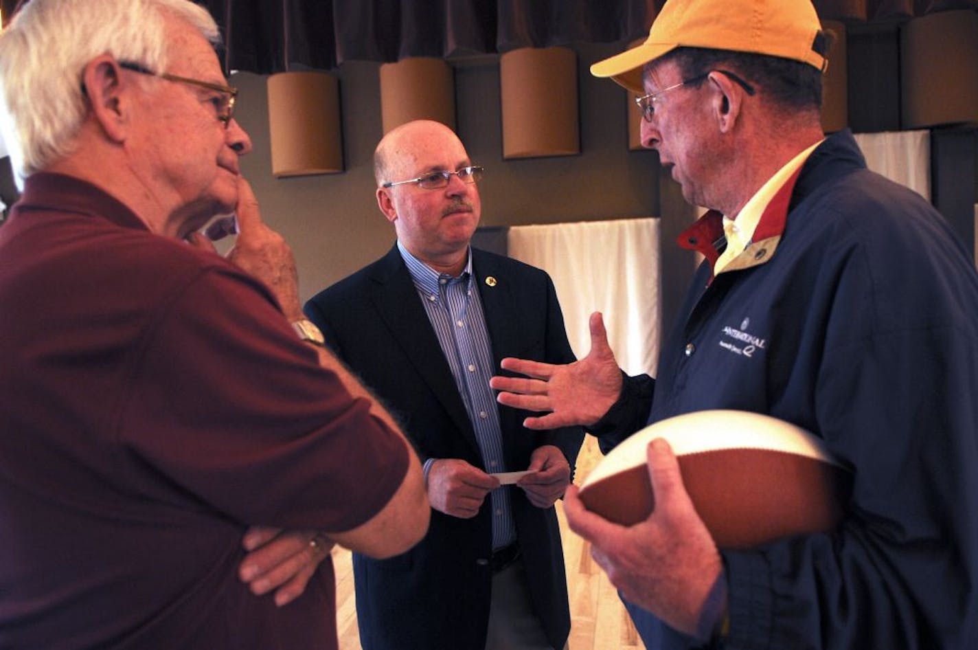 New Gophers football coach Jerry Kill began his "On the Road with Jerry Kill'' tour today. First-day stop was in Hutchinson at the Crow Wing Golf Club and later in the day in Willmar and Mankato. Jerry Kill in the middle listened to Keith Krommenhoek oif Hutchinson a cancer survivor talk about his struggles with Ron Max of Hutchinson on the left. Coach Kill is now 5 years free of cancer and was offering some advice.