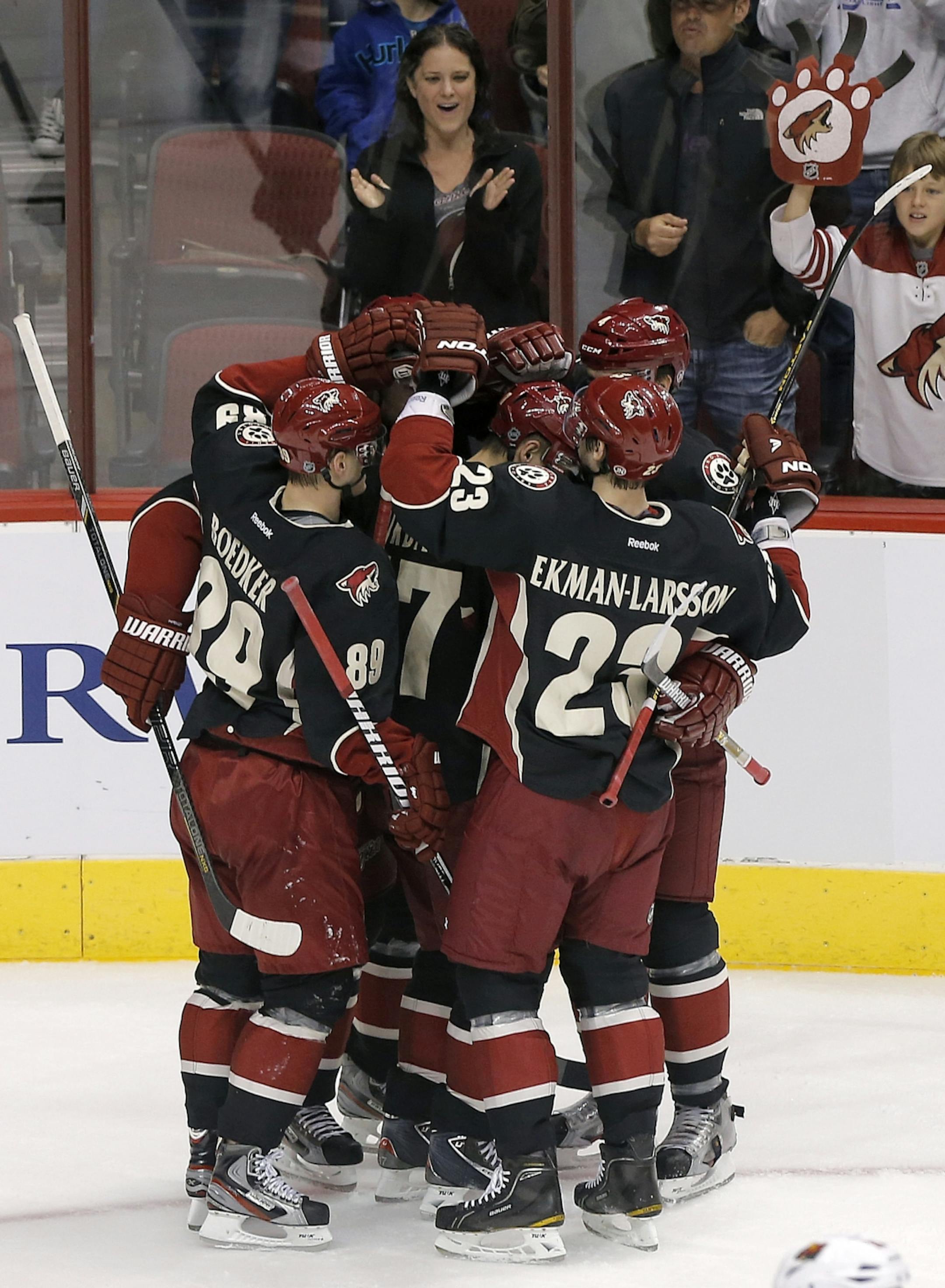 Phoenix Coyotes' Oliver Ekman-Larsson (23), and Mikkel Boedker (89), of Denmark, celebrate teammate Martin Hanzal's (not visible) goal during the second period of an NHL hockey game against the Minnesota Wild, Monday, Feb. 4, 2013, in Glendale, Ariz.