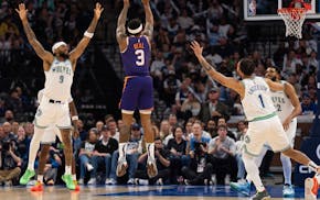 Suns guard Bradley Beal shoots between Wolves defenders Sunday on his way to 36 points in Phoenix's victory at Target Center.