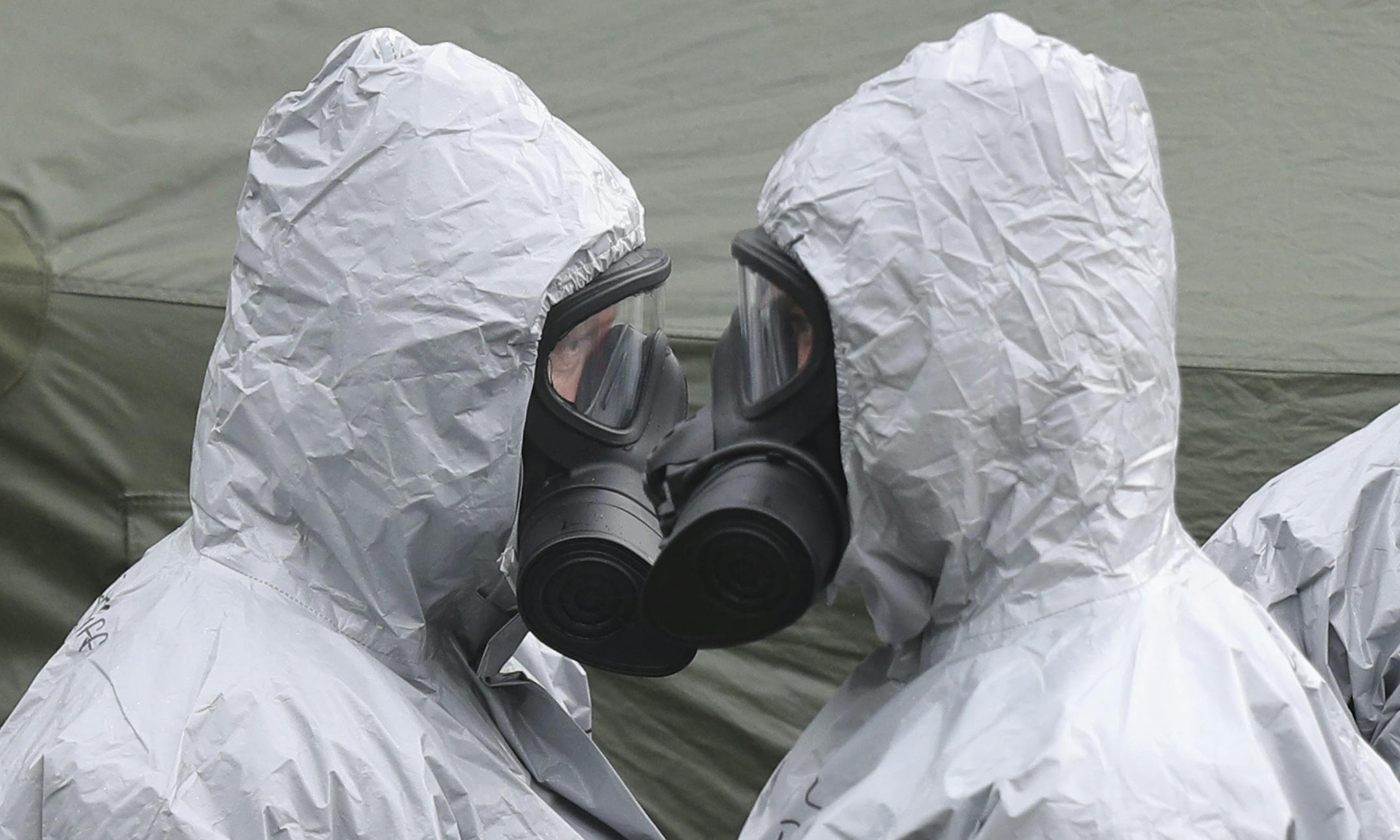 Military personnel in College Street Car Park in Salisbury, Sunday March 11, 2018, as police and members of the armed forces probe the suspected nerve agent attack on Russian double agent Sergei Skripal, which took place on Sunday March 4. British health authorities said Sunday that small traces of contamination have been found in a restaurant and a pub in the English city of Salisbury, after a Russian ex-spy and his daughter were poisoned with a nerve agent. (Andrew Matthews/PA via AP)
