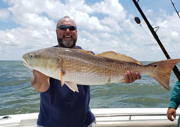 Donn Weber with a bull red drum caught off the coast of Texas.