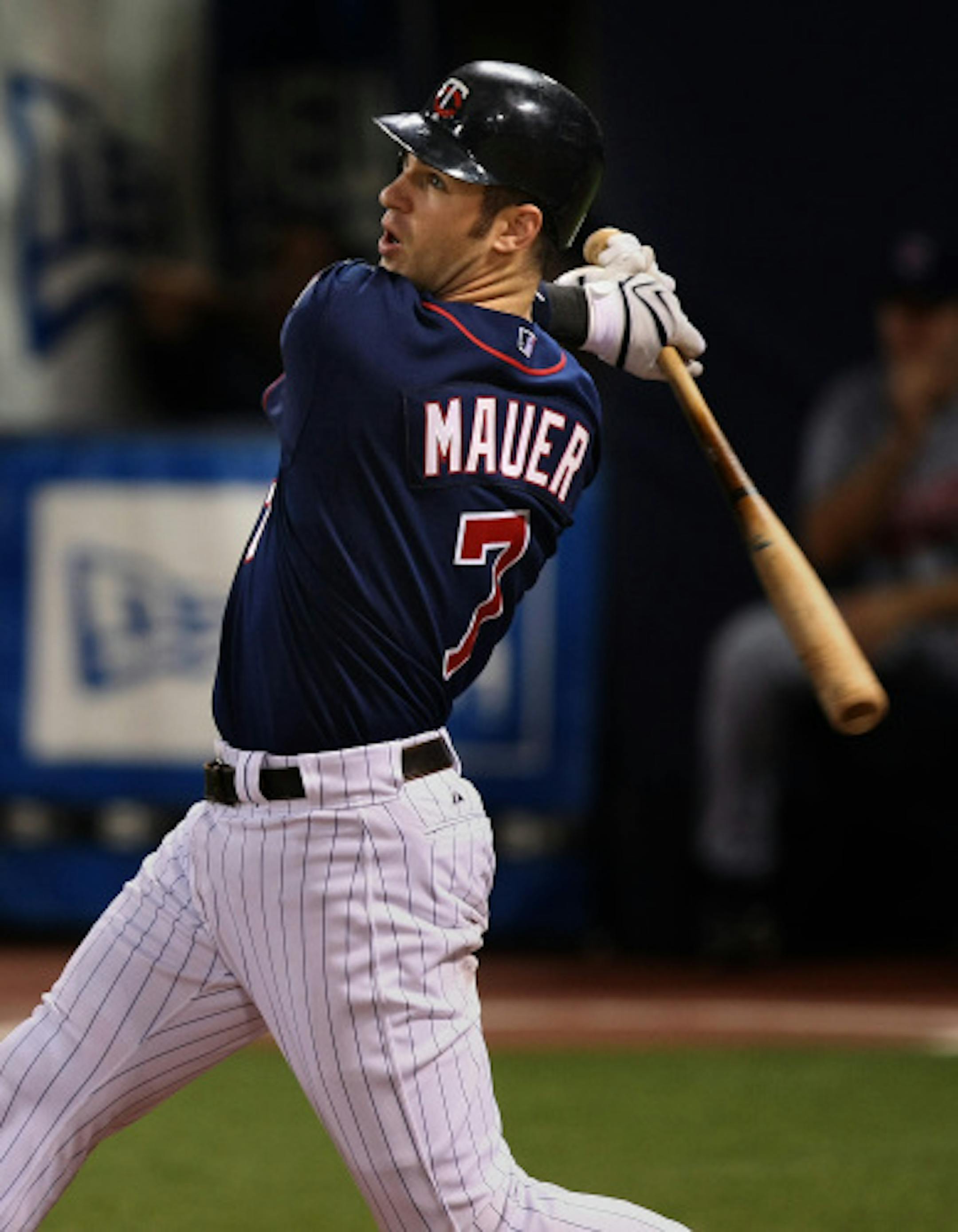Twins catche Joe Mauer watches his 3 run shot leave the ball park in the seventh inning against Cleveland Friday night.