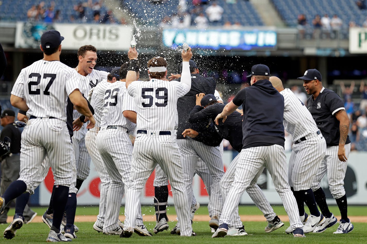 Teammates mob New York Yankees' Gary Sanchez after he hit a walkoff single against the Minnesota Twins during the 10th inning of a baseball game on Monday, Sept. 13, 2021, in New York. (AP Photo/Adam Hunger)