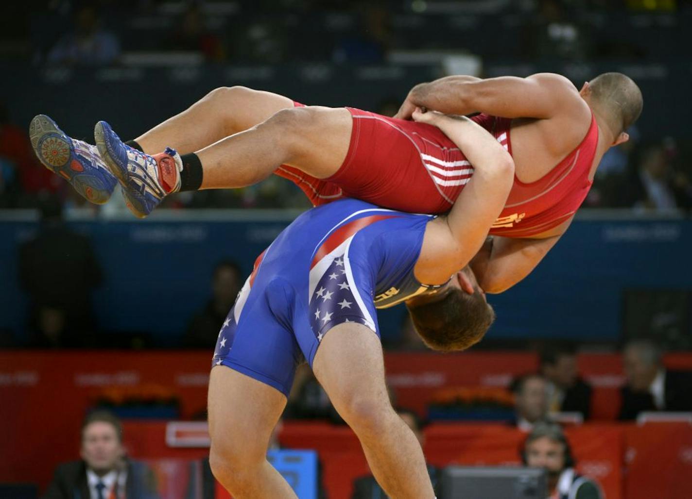 Minnesota's Chas Betts (in blue) won his first-round qualifier match against Keitani Graham of Micronesia in the Men's 84kg Greco-Roman wrestling.