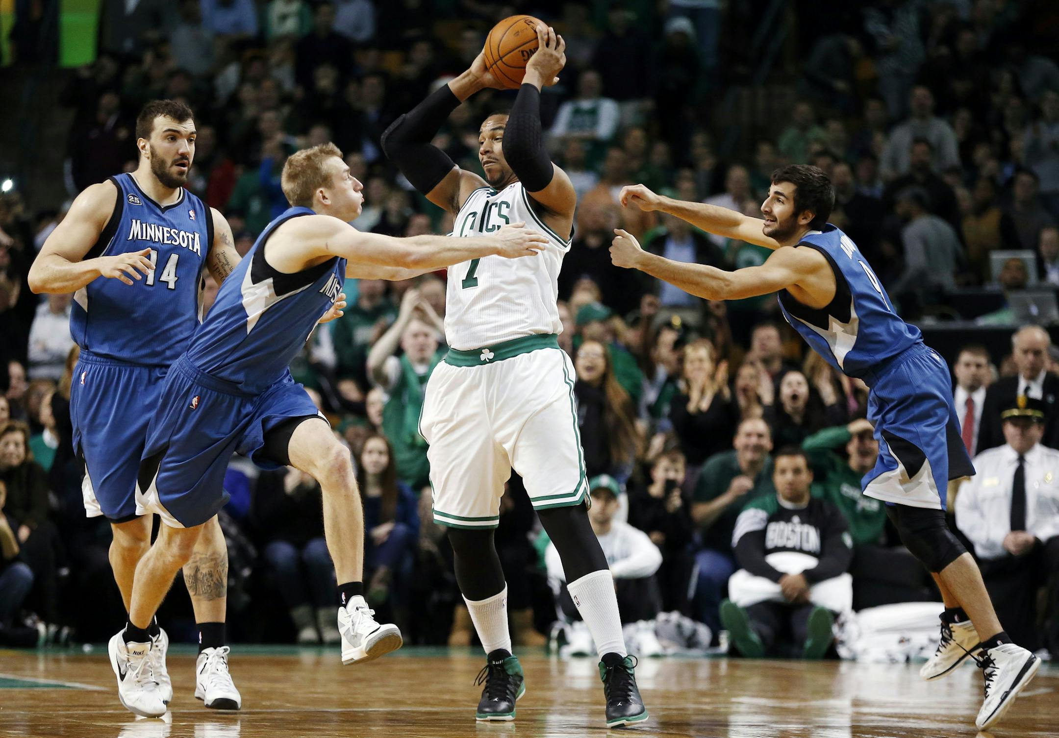 Boston’s Jared Sullinger held onto the ball despite being harassed by the Wolves' Robbie Hummel, second from left, and Ricky Rubio.