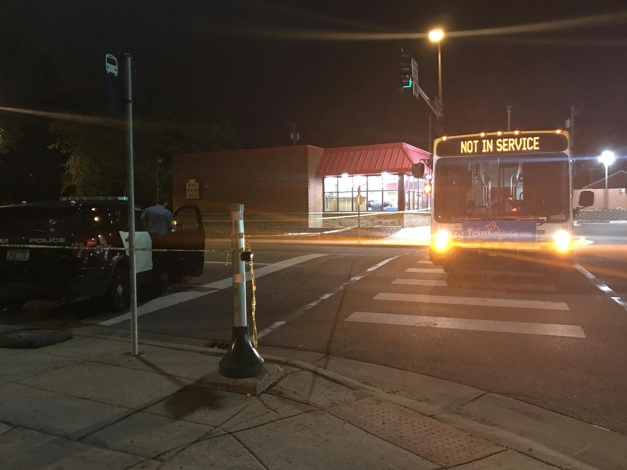 Police used a Metro Transit bus to block the intersection of Knox Av. N. and W. Broadway Ave. in Minneapolis, near scene where a an adult male was found fatally shot in a car Monday evening. Two suspects are in custody in connection with the shooting, police said. Photo by Karen Zamora.