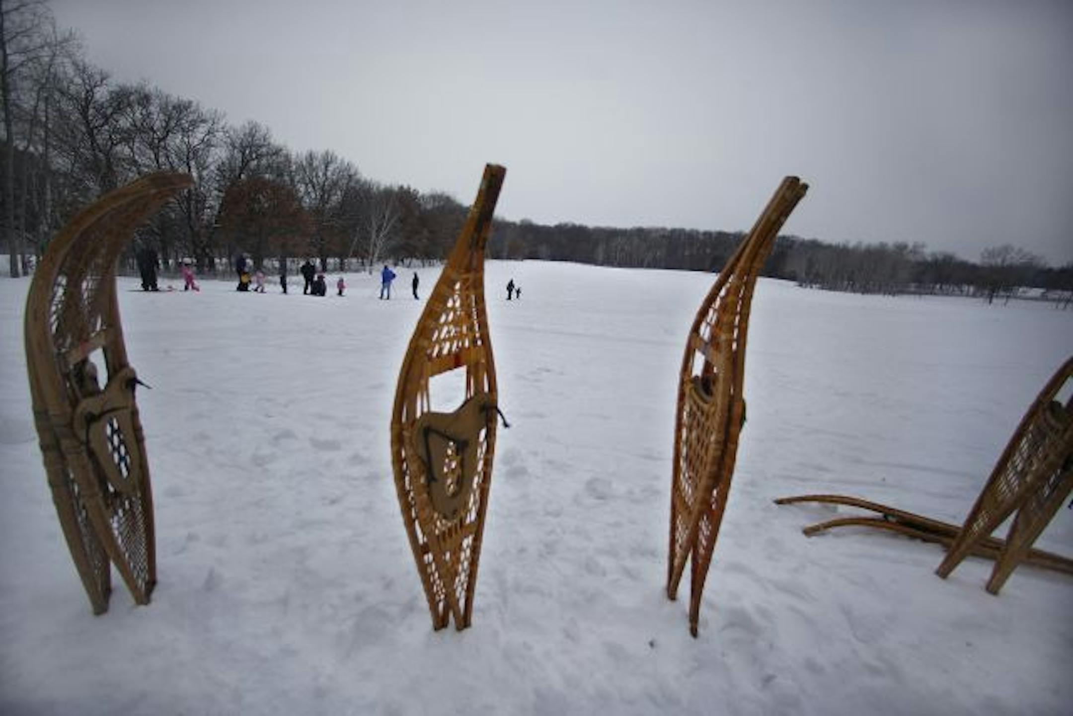 The group walked across an open field, using snowshoes to stay on top of the heavy snow.