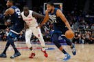 Timberwolves center Karl-Anthony Towns drove past Pistons forward Thon Maker during the second half Monday.