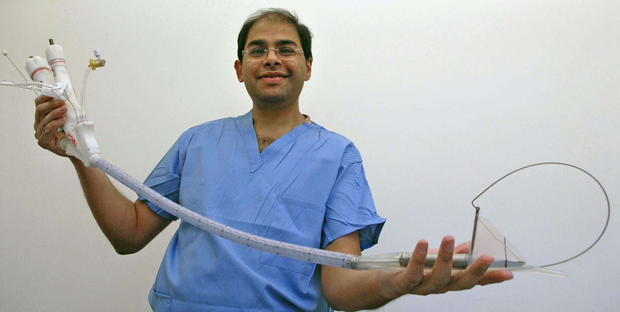 Dr. Sayeed Ikramuddin, a University surgeon, holds Toga a the device that goes down a patients throat to perform the operation.Surgeons at the University of Minnesota are getting ready to start performing a new kind of weight-loss surgery that leaves no scars. It's called natural orifice surgery. In this case, they will use a new device, in effect a high tech stapler, that goes in through the mouth and winds down into the stomach.