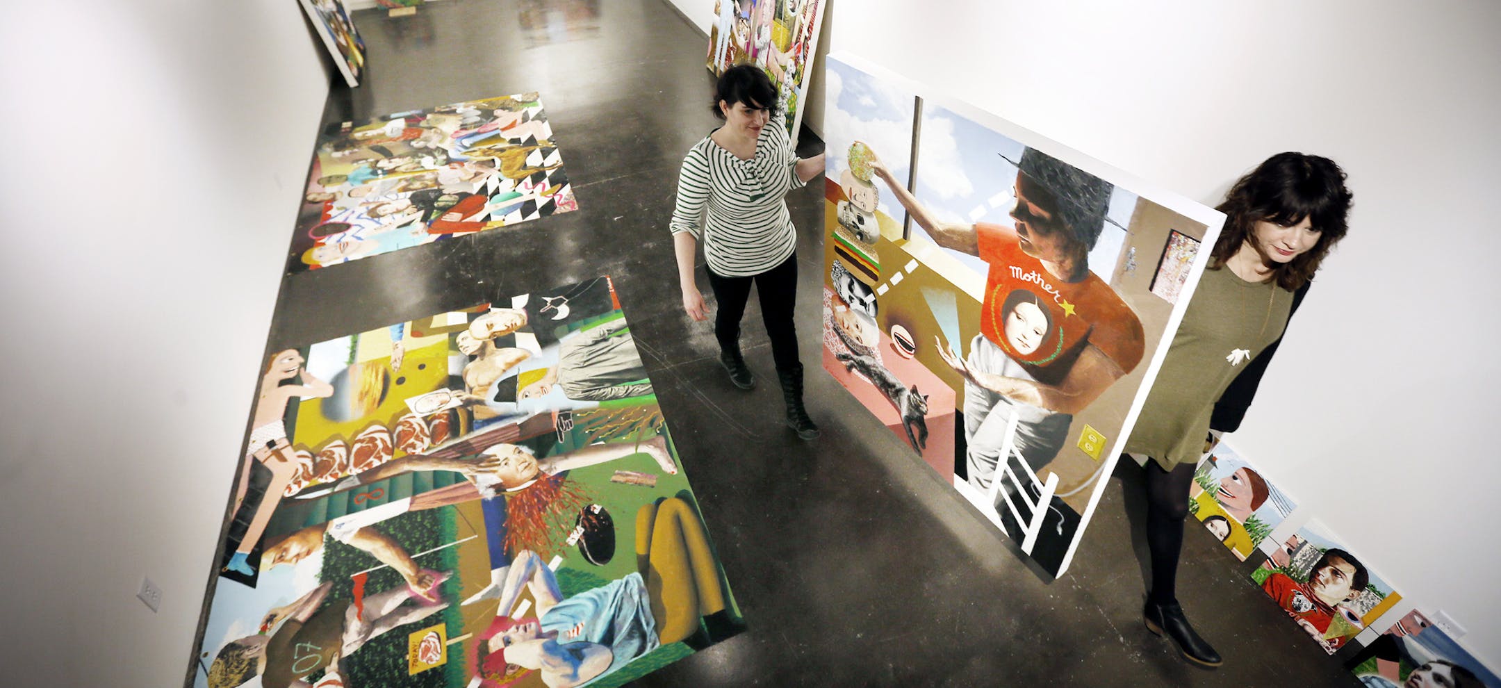 Alison Hiltner left and Carolyn Payne carried a painting by Samual Weinberg Thursday at the Soo Visual Arts Center April 2, 2015 in Minneapolis, Minnesota. ] Jerry Holt/ Jerry.Holt@Startribune.com
