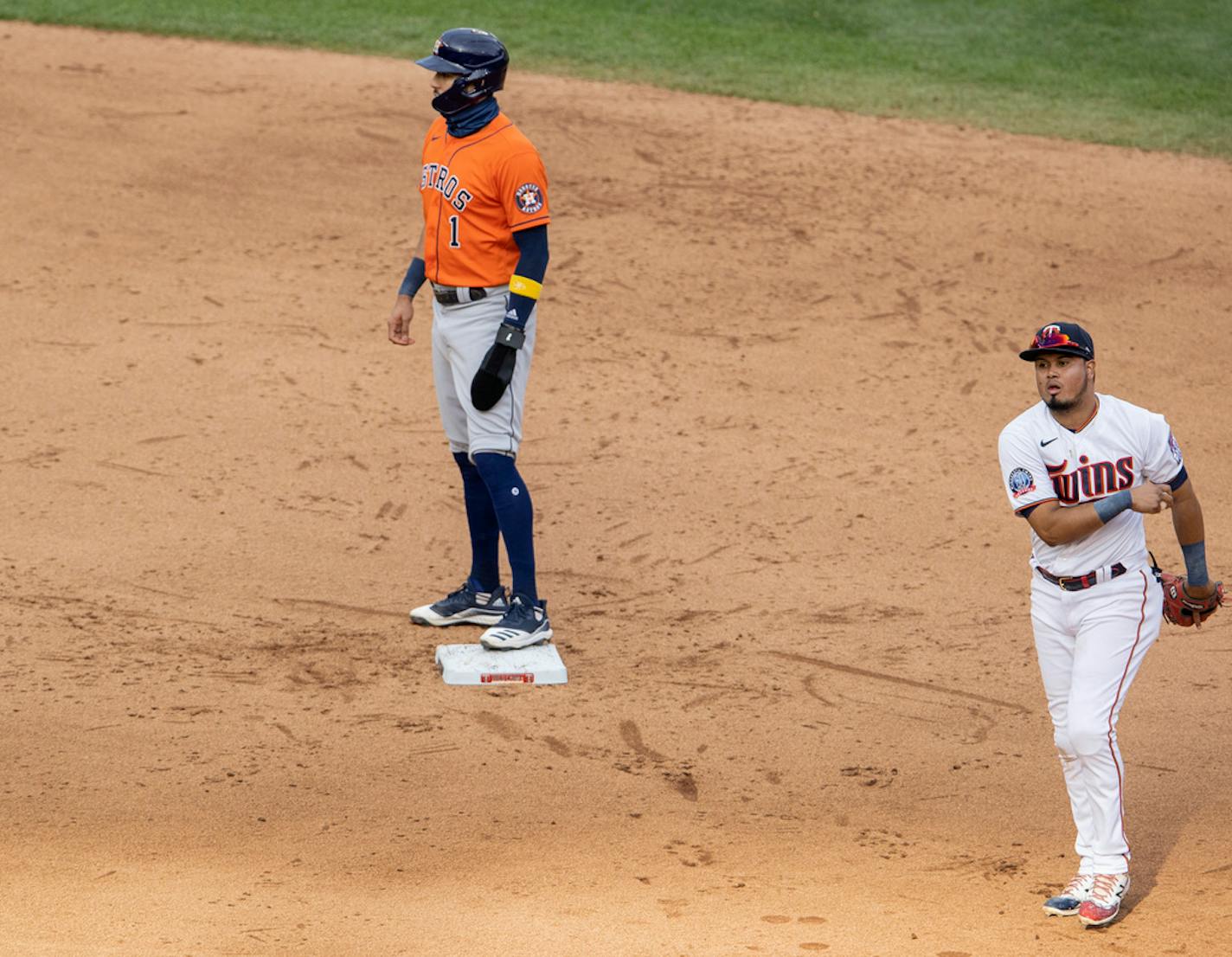 Houston Astros Carlos Correa (1) was safe at second base as Minnesota Twins second baseman Luis Arraez walked with the ball in the ninth inning.