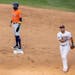 Houston Astros Carlos Correa (1) was safe at second base as Minnesota Twins second baseman Luis Arraez walked with the ball in the ninth inning.