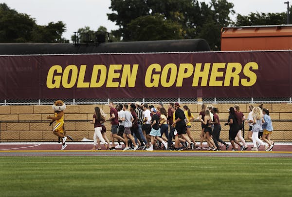 Goldy Gopher and U of M athletes took to the track for the inaugural lap
.] Grand opening of the U's track and field complex, and the long road it too