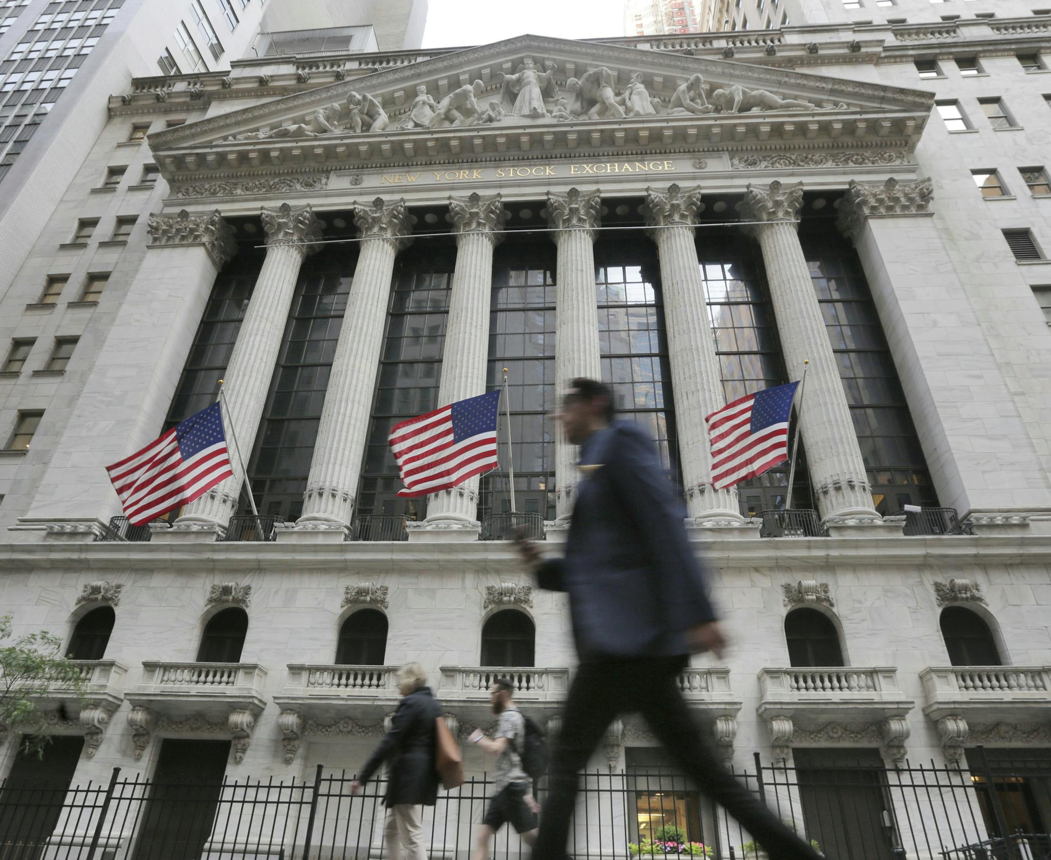 FILE - In this June 24, 2016, file photo, people walk by the New York Stock Exchange. On Monday, Oct. 1, 2018, stocks are opening broadly higher on Wall Street, led by big gains in industrials after General Electric named a new CEO. (AP Photo/Richard Drew, File)
