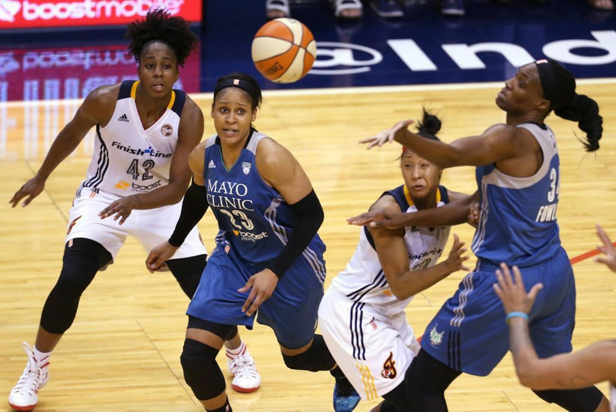 Indiana Fever guard Shenise Johnson (42), from left, Minnesota Lynx forward Maya Moore (23), Indiana Fever guard Briann January (20) and Minnesota Lynx center Sylvia Fowles (34) scramble for the ball during the second half.