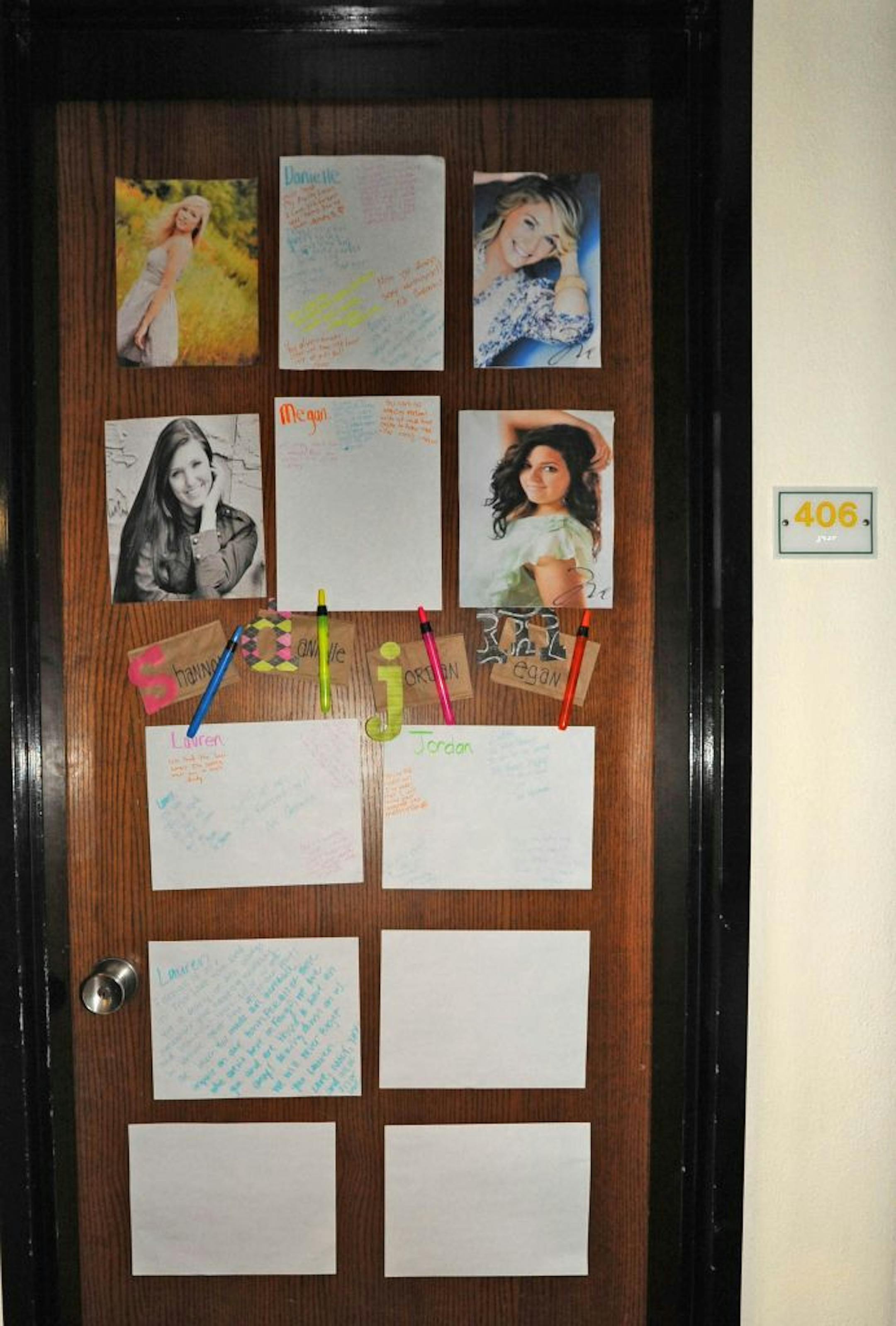 The door on Room 406 in the Sevrinson Hall at North Dakota State University, where three of the crash victims lived, has become an impromptu memorial. From the top left, clockwise: Danielle Renninger, Megan Sample, Jordan Playle and Lauren Peterson.