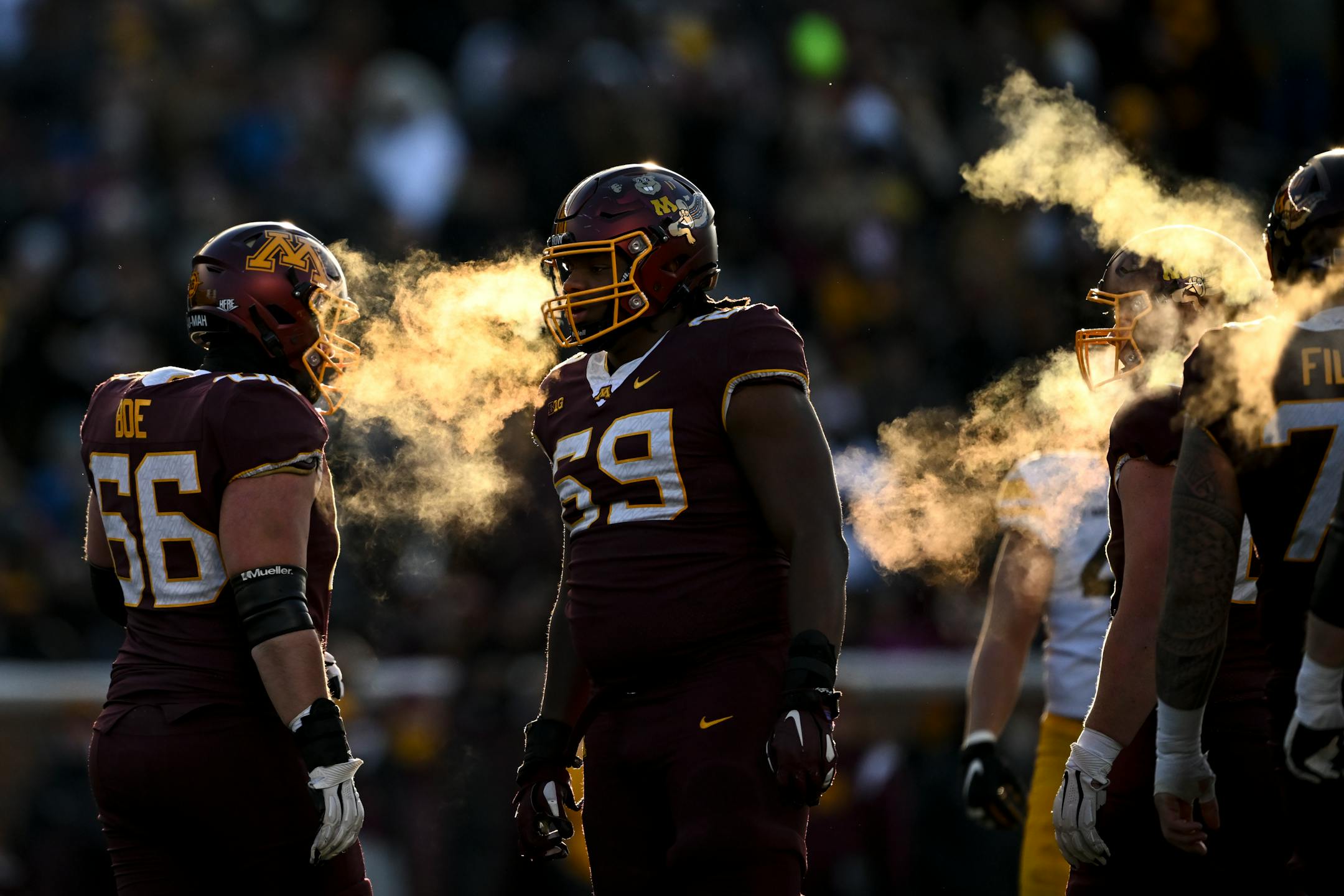 Minnesota Gophers players, including offensive lineman Aireontae Ersery (69), wait for the next snap during the first half.