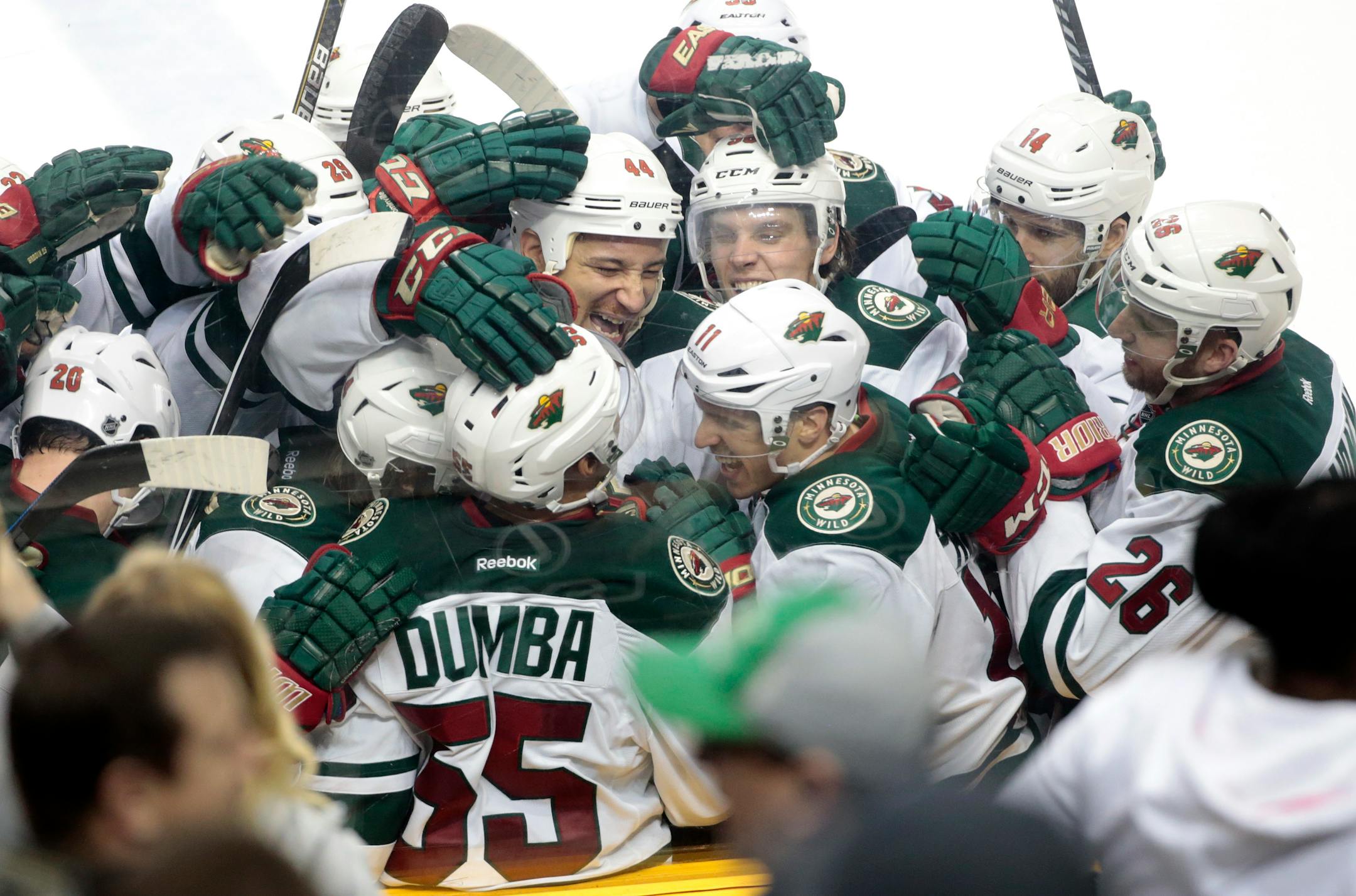 Minnesota Wild defenseman Matt Dumba (55) is mobbed by teammates after he scored the winning goal in overtime against the Nashville Predators in an NHL hockey game Tuesday, March 17, 2015, in Nashville, Tenn. The Wild won 3-2. (AP Photo/Mark Humphrey)
