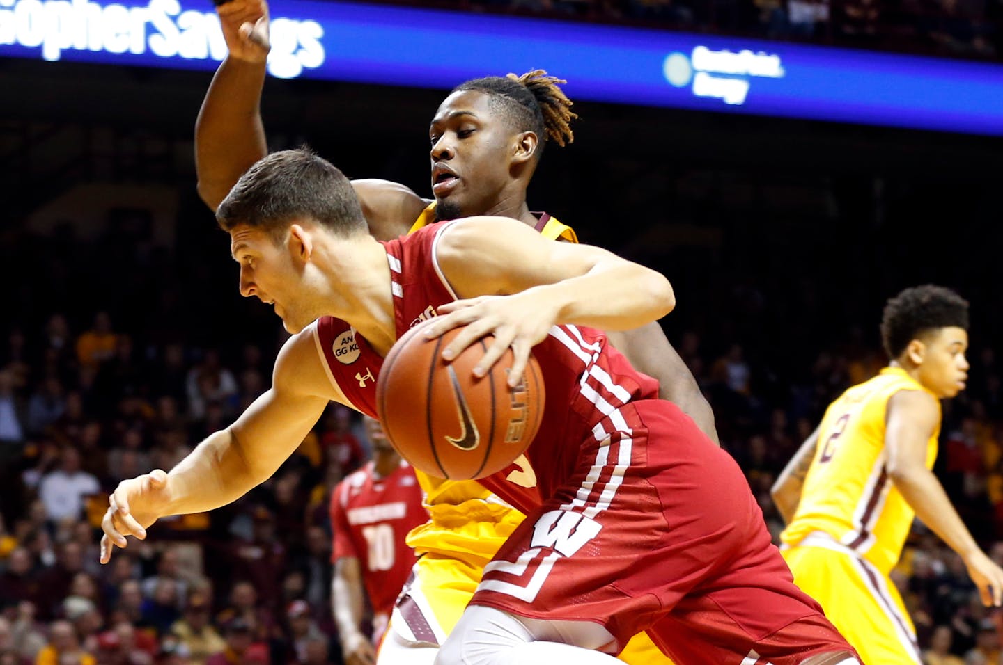 Wisconsin's Zak Showalter, left, drives past Minnesota's Akeem Springs during the first half of an NCAA college basketball game Saturday, Jan. 21, 2017, in Minneapolis. (AP Photo/Jim Mone)