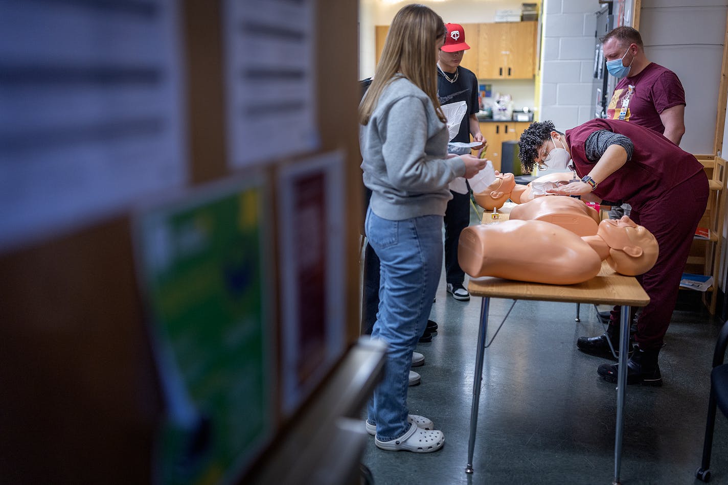 M Health Fairview's community clinical care staff Darcey McCanpbell, center, and Alex Wenzel demonstrate how to handle an overdose situation to a group of students at Washington Technology Magnet School in St. Paul, Minn., on Thursday, Jan. 11, 2024. ] Elizabeth Flores • liz.flores@startribune.com