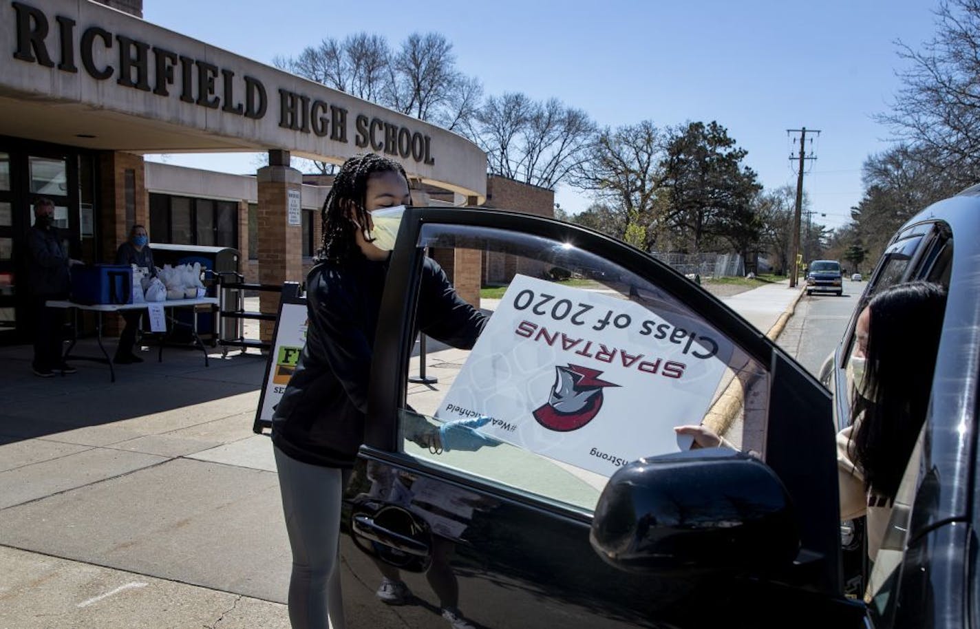 Corina Jones, 16, passed out Class of 2020 yard signs to seniors at Richfield High School on Thursday.