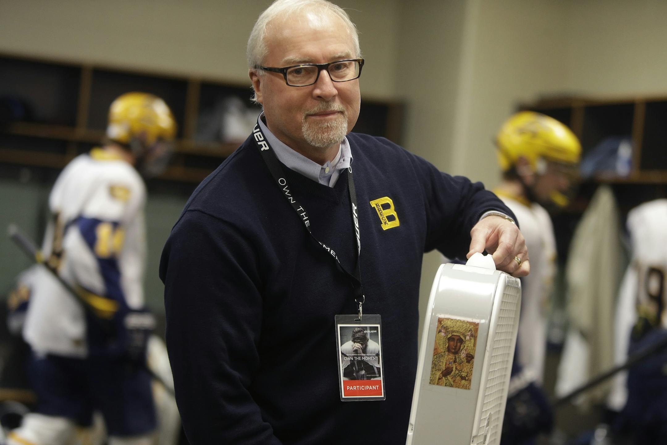 Breck's Head Coach Les Larson held the "lucky" fan up before talking to his team in the locker room at the Class 1A boys' hockey state tournament semifinals at the Xcel Energy Center, Thursday, March 8, 2013 in St. Paul, MN.(ELIZABETH FLORES/STAR TRIBUNE) ELIZABETH FLORES � eflores@startribune.com