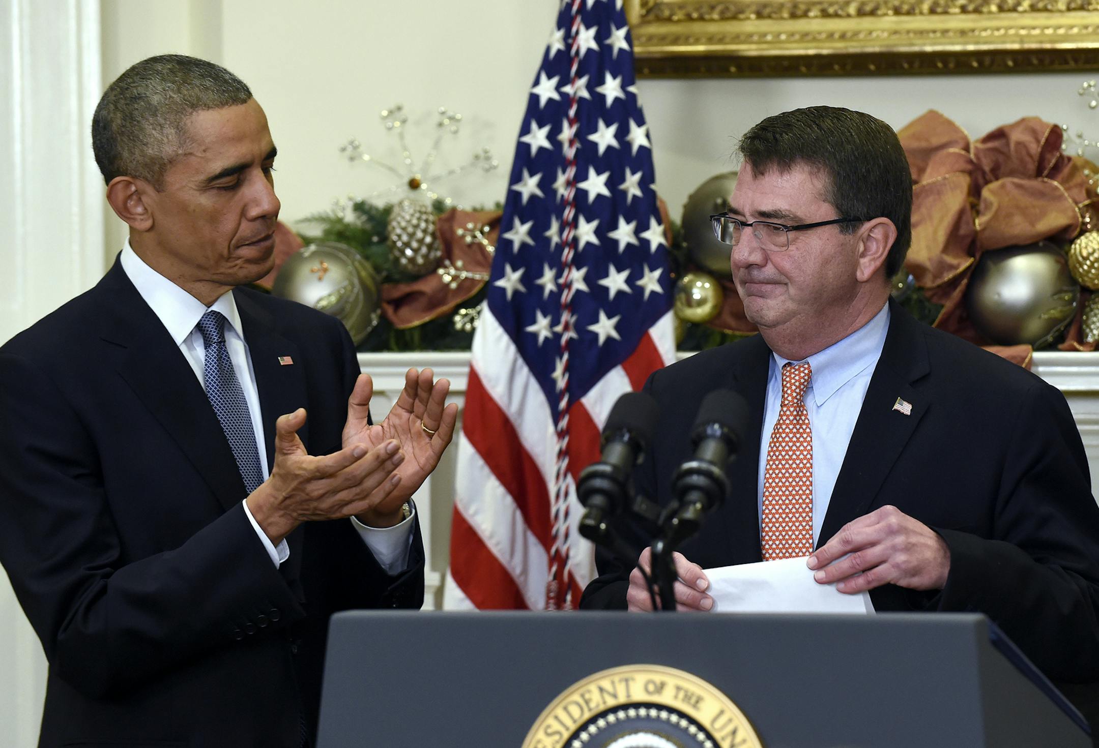 President Barack Obama applauds Ashton Carter his nominee for defense secretary, during the announcement, Friday, Dec. 5, 2014, in the Roosevelt Room of the White House in Washington. (AP Photo/Susan Walsh) ORG XMIT: DCSW104