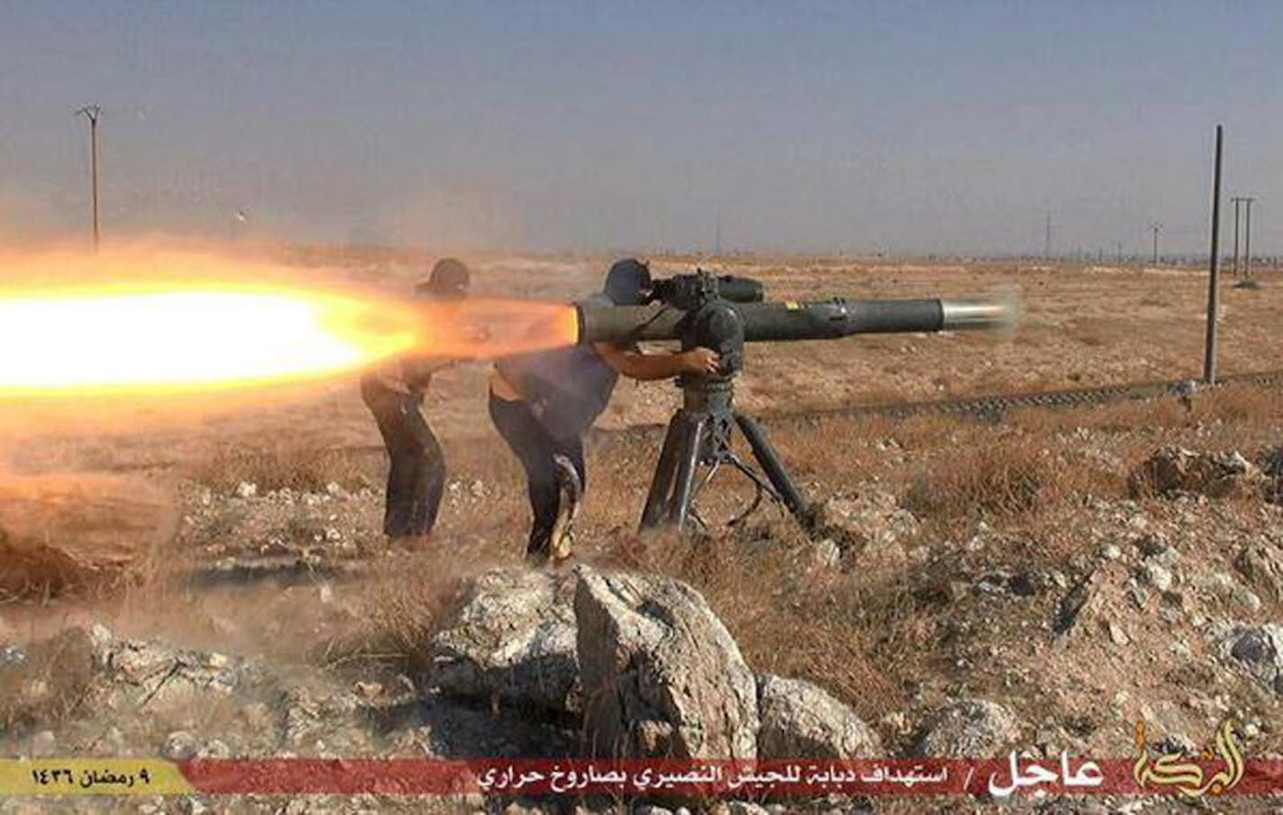 In this picture released on June 26, 2015, by a website of Islamic State militants, Islamic State militants fire an anti-tank missile in Hassakeh, northeast Syria.