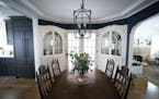 Designer Tasha Schultz combined a vintage dining set with on-trend navy blue paint in her Falcon Heights dining room.