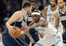 Luka Doncic of the Mavericks is defended by Jaden McDaniels of the Timberwolves in the first quarter of Game 1 of the Western Conference finals.