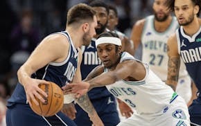 The Mavericks' Luka Doncic is defended by the Timberwolves' Jaden McDaniels during the first quarter of Game 1 of the Western Conference finals.