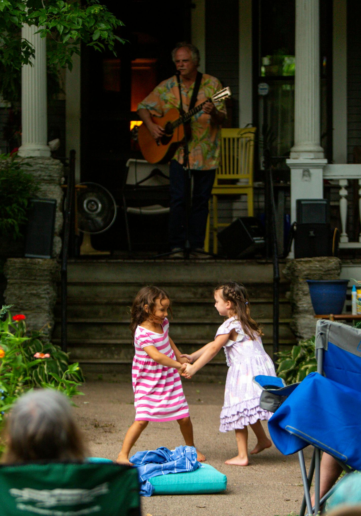 [A front yard performance by guitarist Pat Donohue of "Praire Home Companion" was hosted at Dick CohnÕs home in St. Paul Friday, August 7, 2020. NICOLE NERI ¥ Special to the Star Tribune] Two young girls dance at a front yard performance by guitarist Pat Donohue of "Praire Home Companion" at Dick CohnÕs home in St. Paul Friday, August 7, 2020.