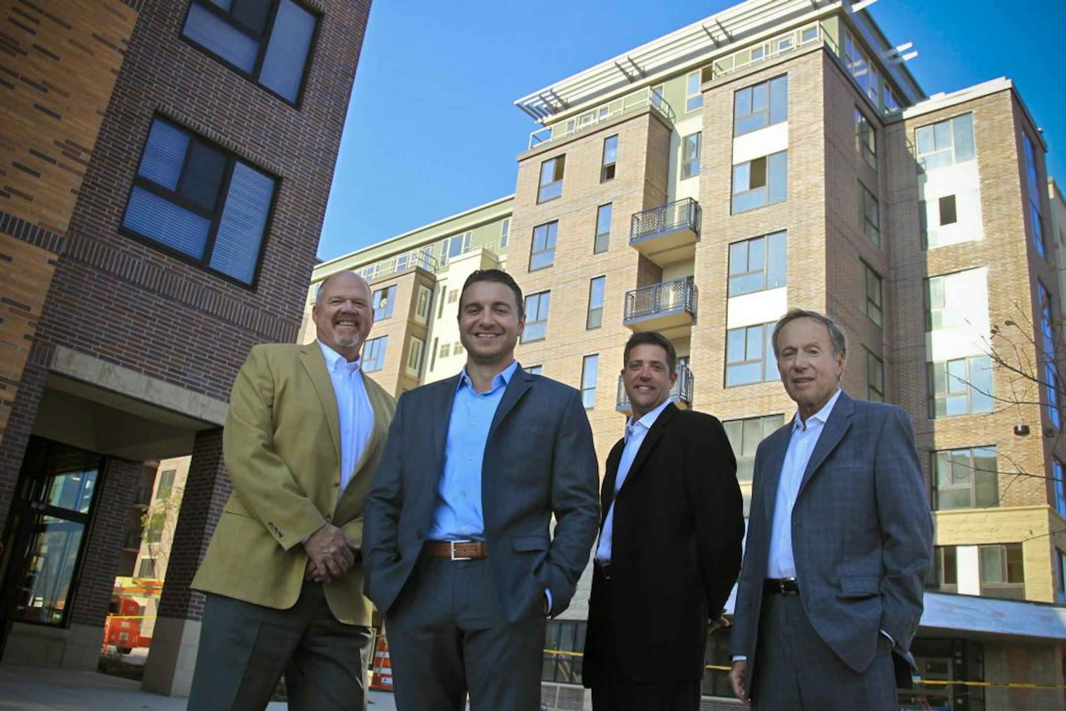 In front of the Genesee Apartments in Bloomington this week were several of those who made the project happen: from left, Keith Ulstad, United Properties senior vice president; Brandon Champeau, development manager for United Properties; Ryan Dunlay, vice president of apartment developer Stuart Development Corp., and Stuart Nolan, founder and chairman of Stuart Development.
