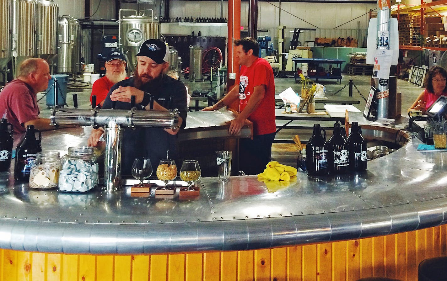 Assistent-brewer Brian Priefer pours a beer at American Sky Brewing in Hudson, Wis. ORG XMIT: MIN1410071011531865