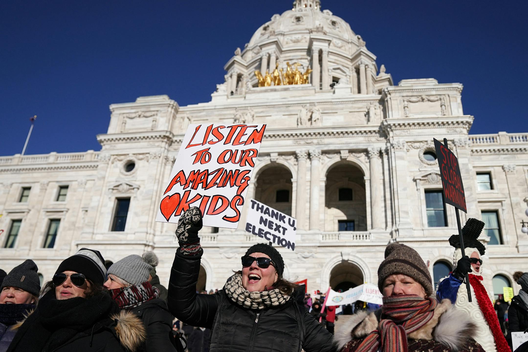 Patsy Stinchfield cheered with her sign as she stood on the steps of the State Capitol during the Women's March Saturday. ] ANTHONY SOUFFLE • anthony.souffle@startribune.com People gathered for the Women's March Minnesota Saturday, Jan. 19, 2019 at the State Capitol in St. Paul, Minn. The march was in conjunction with over 175 sister marches across the country.