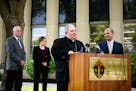 Archbishop Bernard Hebda, right of center, spoke to the media about the settlement reached between abuse survivors and the Archdiocese of St. Paul and
