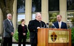 Archbishop Bernard Hebda, right of center, spoke to the media about the settlement reached between abuse survivors and the Archdiocese of St. Paul and