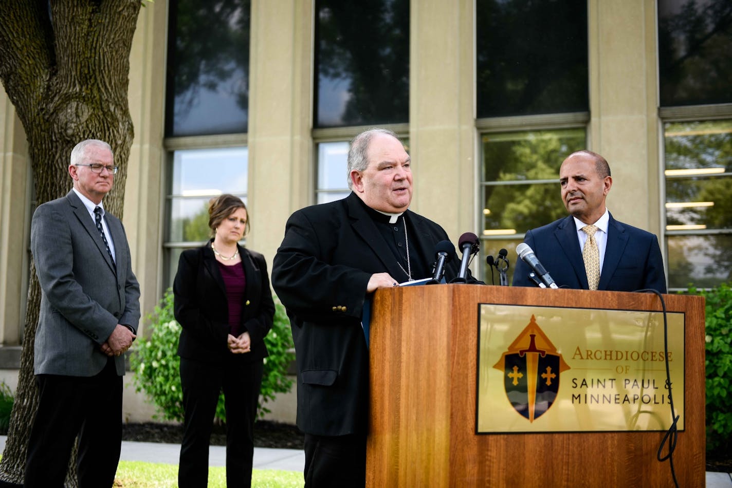 Archbishop Bernard Hebda, right of center, spoke to the media about the settlement reached between abuse survivors and the Archdiocese of St. Paul and Minneapolis Thursday. To his left are Janell Rasmussen, deputy director of the Office of Ministerial Standards and Safe Environment, Tim O'Malley, director of the Office of Ministerial Standards and Safe Environment, and to Hebda's right, Thomas J. Abood, chair of the Archdiocesan Finance Council and Reorganization task Force.