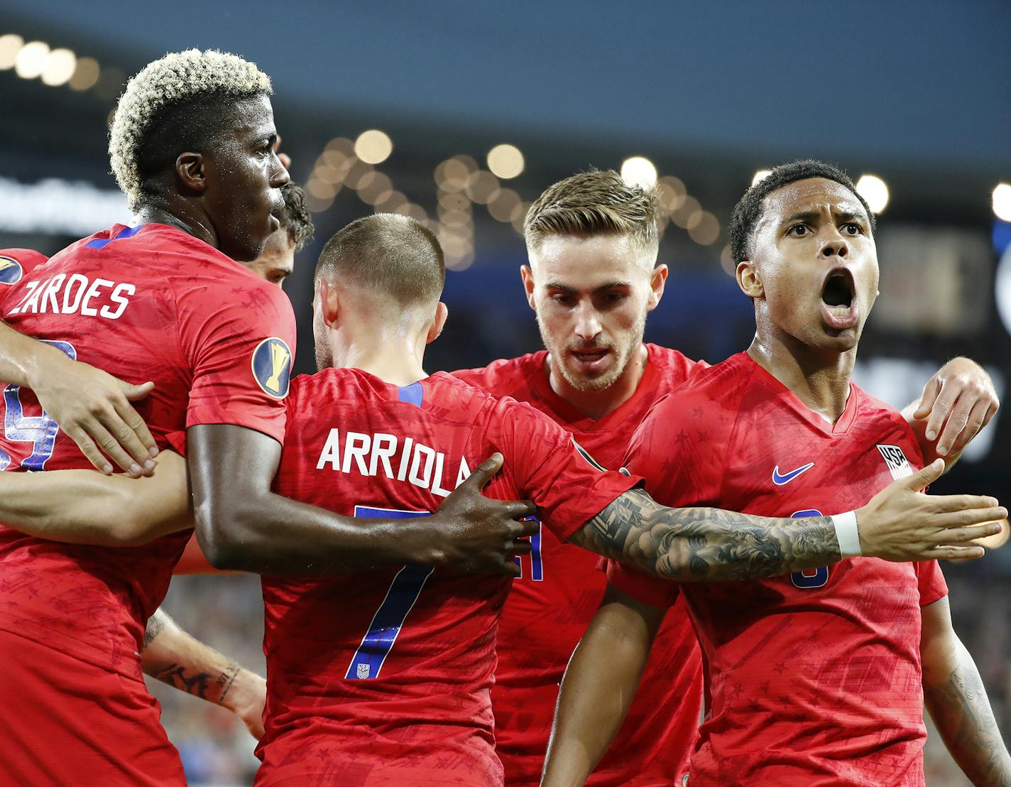 USA forward Paul Arriola, center, celebrates his goal with teammates Gyasi Zardes (9), from left, Tyler Boyd (21) and Weston Mckennie (8) during the first half.