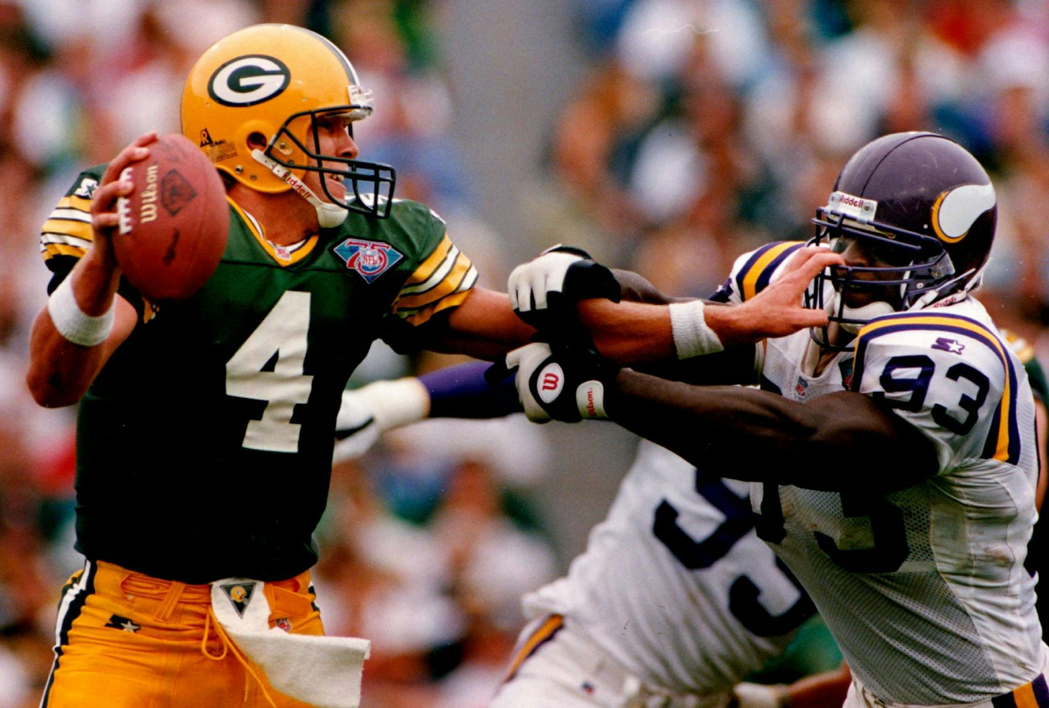 September 5, 1994 Packers quarterback Brett Favre got a handful of John Randle's facemask as he held the Vikings defender at bay to avoid a sack before throwing an incomplete pass. Jerry Holt, Minneapolis Star Tribune ORG XMIT: MIN2015071719211879