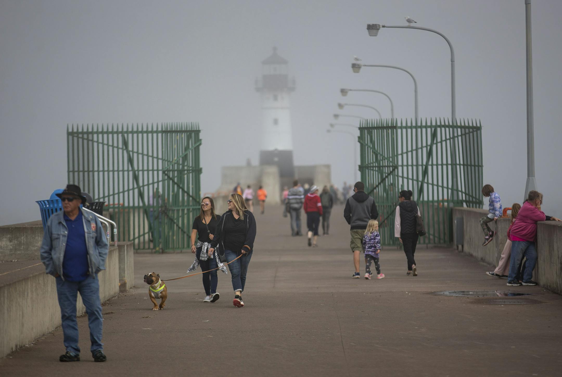 Tourists and locals move through Canal Park in front of the Duluth Harbor North Pier Light on Monday September 16, 2019.]
ALEX KORMANN &#x2022; alex.kormann@startribune.com